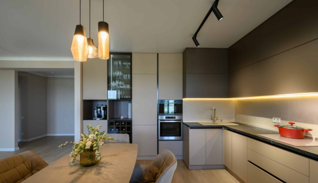  A contemporary kitchen design using layered lighting — including under-cabinet LED strips and pendant fixtures for better visibility and ambiance.